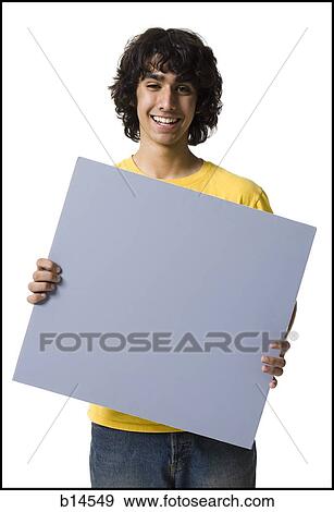 Teenage boy holding blank sign View Large Photo Image Stock Photo - Teenage boy holding blank sign. Fotosearch