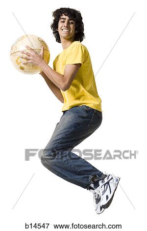 Stock Photo - Teenage boy leaping with globe smiling. Fotosearch