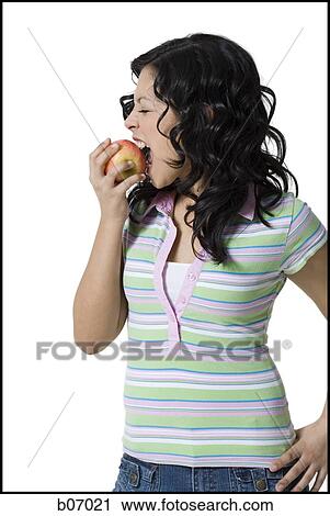 Teenage girl biting an apple View Large Photo Image Stock Image - Teenage girl biting an apple. Fotosearch