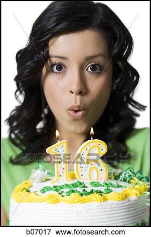 Teenage girl blowing on birthday candles View Large Photo Image Stock Photo - Teenage girl blowing on birthday candles. Fotosearch