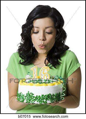 Teenage girl blowing on birthday candles View Large Photo Image Stock Photography - Teenage girl blowing on birthday candles. Fotosearch