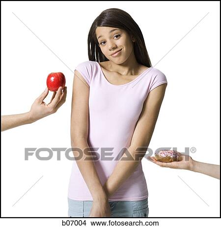 Picture - Teenage girl choosing between good and evil. Fotosearch