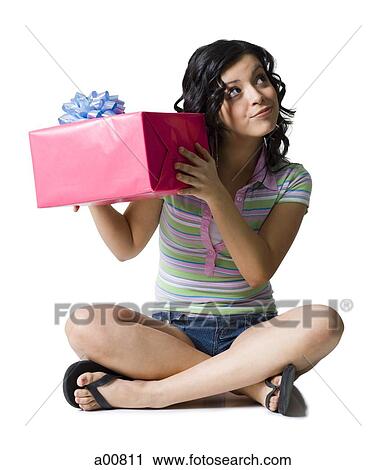 Teenage girl guessing with gift box View Large Photo Image Stock Image - Teenage girl guessing with gift box. Fotosearch
