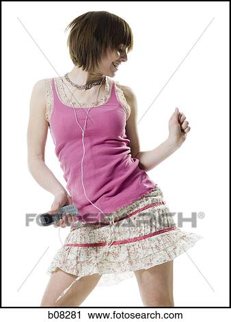 Teenage girl holding a cell phone and listening to music View Large Photo Image Stock Image - Teenage girl holding a cell phone and listening to music. Fotosearch