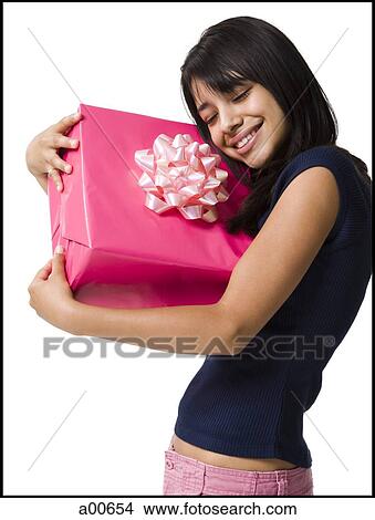 Teenage girl holding a gift View Large Photo Image Picture - Teenage girl holding a gift. Fotosearch