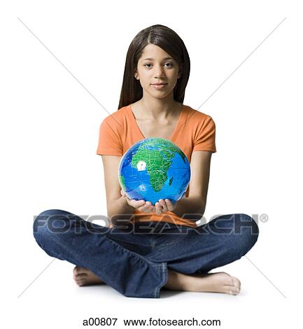 Stock Photo - Teenage girl holding earth globe. Fotosearch