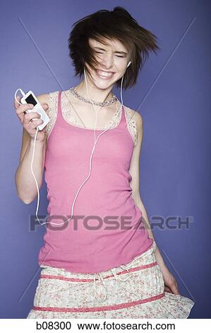 Teenage girl listening to an MP3 player View Large Photo Image Stock Image - Teenage girl listening to an MP3 player. Fotosearch