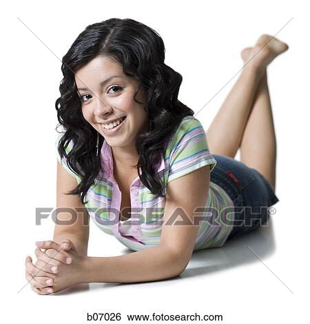 Teenage girl lying down with hands clasped View Large Photo Image Stock Photograph - Teenage girl lying down with hands clasped. Fotosearch