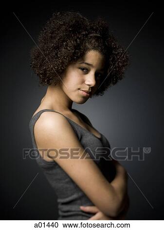 Teenage girl standing with arms crossed View Large Photo Image Stock Image - Teenage girl standing with arms crossed. Fotosearch