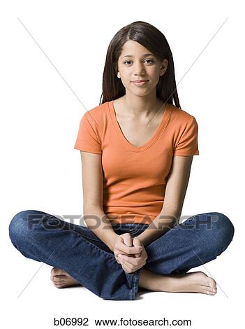 Stock Image - Teenage girl with crossed legs. Fotosearch