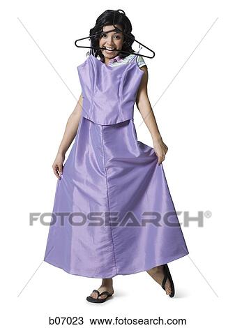 Teenage girl with dress and hanger in mouth View Large Photo Image Stock Image - Teenage girl with dress and hanger in mouth. Fotosearch