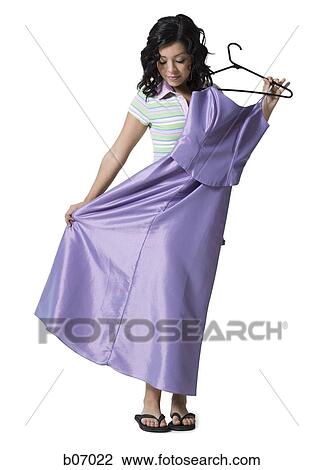 Teenage girl with dress and hanger View Large Photo Image Stock Image - Teenage girl with dress and hanger. Fotosearch