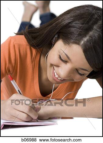 Teenage girl writing in notebook View Large Photo Image Stock Photo - Teenage girl writing in notebook. Fotosearch