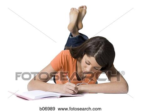 Teenage girl writing in notebook View Large Photo Image Stock Photo - Teenage girl writing in notebook. Fotosearch