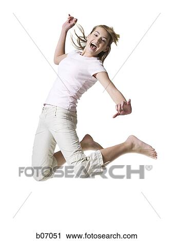 Stock Image - Teenager jumping in the air. Fotosearch