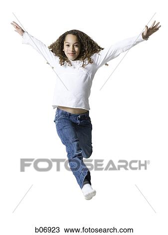 Stock Image - Teenager jumping with arms extended. Fotosearch