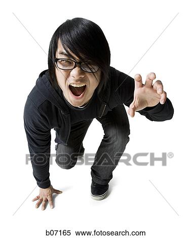Teenager making funny face and claw gesture View Large Photo Image Stock Photography - Teenager making funny face and claw gesture. Fotosearch