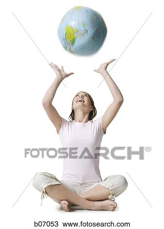 Teenager tossing earth globe View Large Photo Image Stock Image - Teenager tossing earth globe. Fotosearch