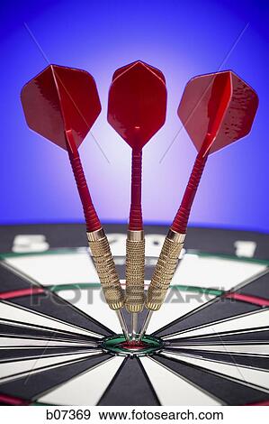 Three darts resting in bulls eye View Large Photo Image Stock Photo - Three darts resting in bulls eye. Fotosearch