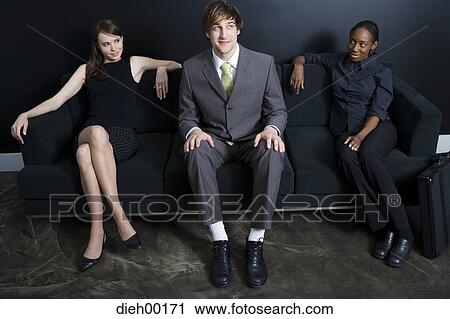 Three office workers sitting on couch View Large Photo Image Stock Image - Three office workers sitting on couch. Fotosearch