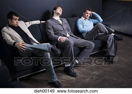 Three office workers sitting on couch View Large Photo Image Stock Photo - Three office workers sitting on couch. Fotosearch