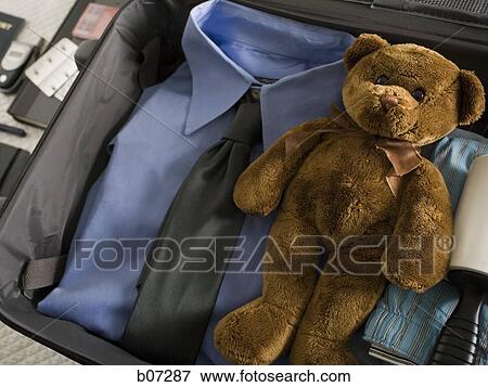 Travelling bag with personal effects and teddy bear View Large Photo Image Stock Photo - Travelling bag with personal effects and teddy bear. Fotosearch