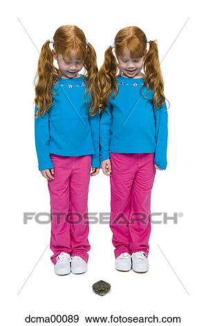 Twin sisters watching turtle View Large Photo Image Stock Photo - Twin sisters watching turtle. Fotosearch
