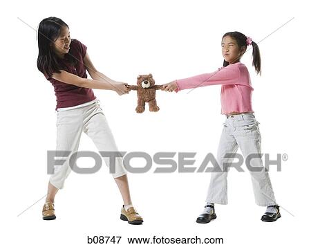 Two girls fighting over a teddy bear View Large Photo Image Stock Photo - Two girls fighting over a teddy bear. Fotosearch