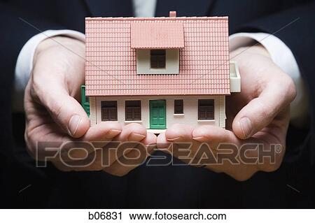 Two hands holding model of house View Large Photo Image Stock Image - Two hands holding model of house. Fotosearch