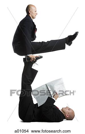 Two male acrobats in business suits performing View Large Photo Image Picture - Two male acrobats in business suits performing. Fotosearch