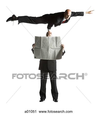 Two male acrobats in business suits performing View Large Photo Image Stock Image - Two male acrobats in business suits performing. Fotosearch