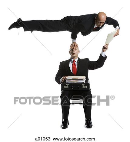 Two male acrobats in business suits performing View Large Photo Image Stock Image - Two male acrobats in business suits performing. Fotosearch