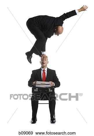 Stock Photo - Two male acrobats in business suits performing. Fotosearch