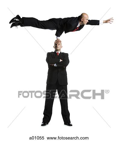 Two male acrobats in business suits performing View Large Photo Image Stock Photography - Two male acrobats in business suits performing. Fotosearch