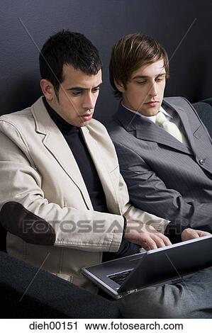 Two male office workers with laptop View Large Photo Image Stock Image - Two male office workers with laptop. Fotosearch