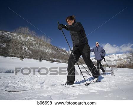 Two people cross country skiing View Large Photo Image Stock Photo - Two people cross country skiing. Fotosearch