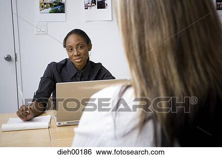 Two women in a meeting View Large Photo Image Stock Photograph - Two women in a meeting. Fotosearch