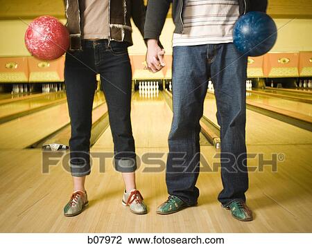 Stock Image - Waist down shot of male and female bowlers. Fotosearch