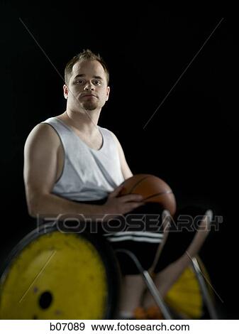 Wheelchair athlete holding basketball View Large Photo Image Stock Photo - Wheelchair athlete holding basketball. Fotosearch