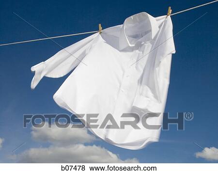 White cotton shirt hanging on a clothesline View Large Photo Image Stock Photo - White cotton shirt hanging on a clothesline. Fotosearch