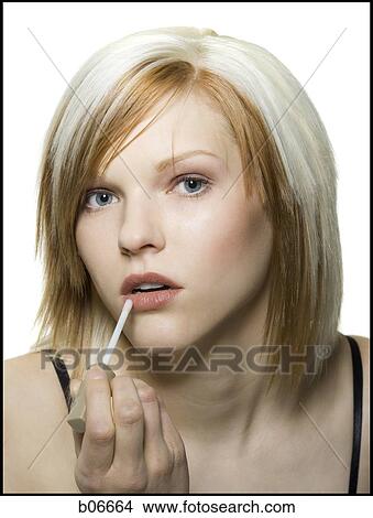 Woman applying cosmetics View Large Photo Image Picture - Woman applying cosmetics. Fotosearch