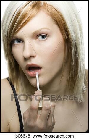 Woman applying make up View Large Photo Image Stock Photo - Woman applying make up. Fotosearch