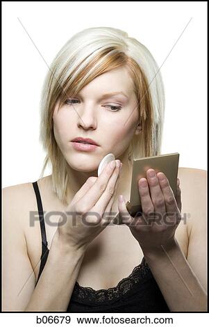 Woman applying make up View Large Photo Image Stock Photo - Woman applying make up. Fotosearch