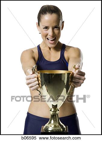 Woman athlete holding trophy View Large Photo Image Stock Photography - Woman athlete holding trophy. Fotosearch