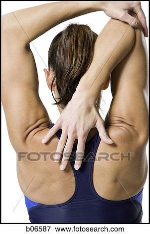 Woman athlete reaching for back View Large Photo Image Stock Photo - Woman athlete reaching for back. Fotosearch