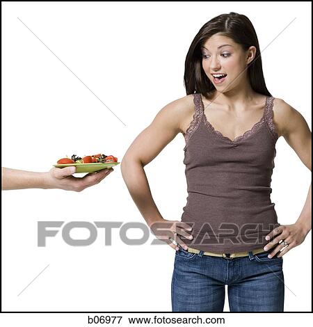 Woman being offered a plate of healthy food View Large Photo Image Stock Photo - Woman being offered a plate of healthy food. Fotosearch