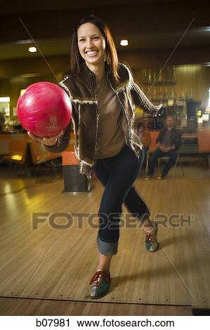 Woman bowling in alley View Large Photo Image Stock Image - Woman bowling in alley. Fotosearch