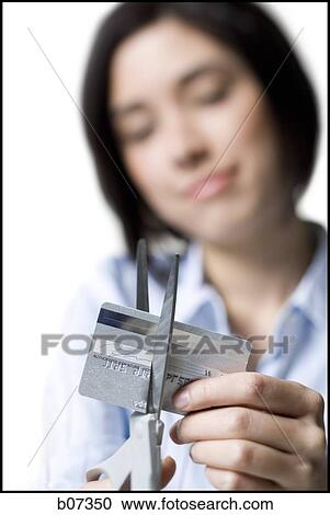 Woman cutting credit card View Large Photo Image Stock Image - Woman cutting credit card. Fotosearch