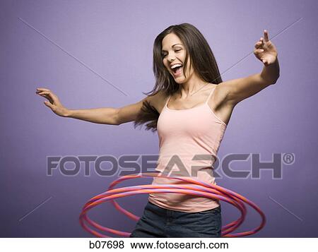Woman dancing and playing with hula hoops View Large Photo Image Stock Photo - Woman dancing and playing with hula hoops. Fotosearch