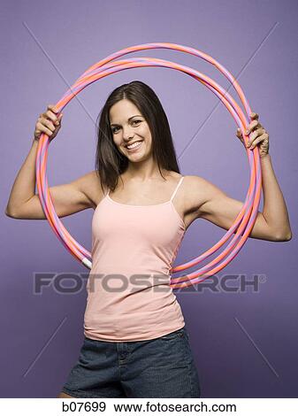 Woman dancing and playing with hula hoops View Large Photo Image Stock Photo - Woman dancing and playing with hula hoops. Fotosearch